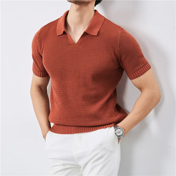 Person wearing a rust-colored knitted short-sleeve shirt against a white background