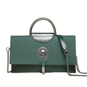 Green handbag with silver handle and chain detail on a white background
