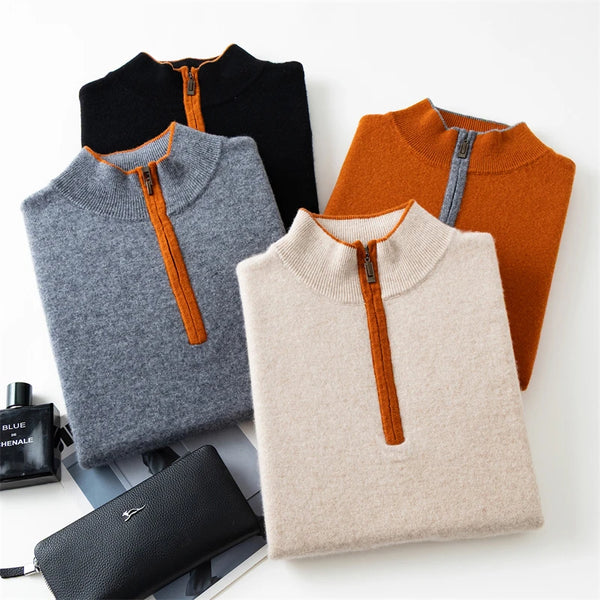 Four folded sweaters in black, gray, orange, and beige with orange zippers on a white surface.