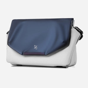Blue and white shoulder bag with a visible brand logo on a light gray background