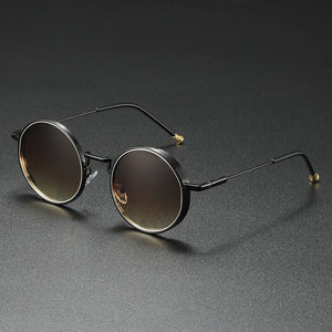 Round sunglasses with black frame and gradient lenses on a dark gray background