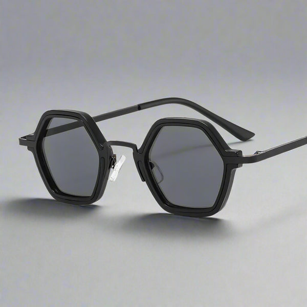 Black hexagonal sunglasses with dark lenses on a white background