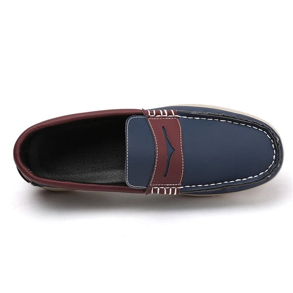 Navy loafer with brown leather strap on a white background