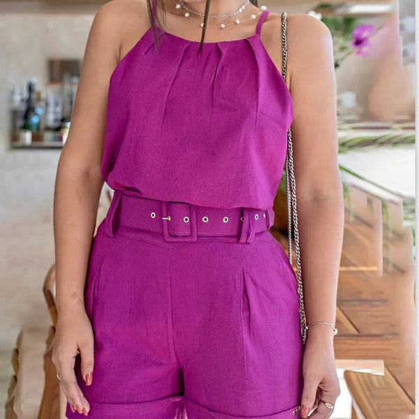 Person wearing a bright purple outfit with a belt in an indoor setting