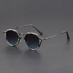 Round sunglasses with dark lenses on a gray background