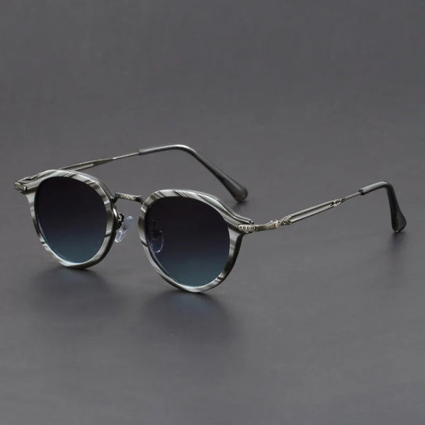 Round sunglasses with dark lenses on a gray background