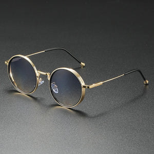 Round gold-framed glasses on a dark gray background