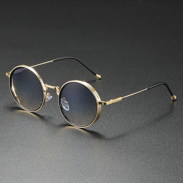 Round gold-framed glasses on a dark gray background