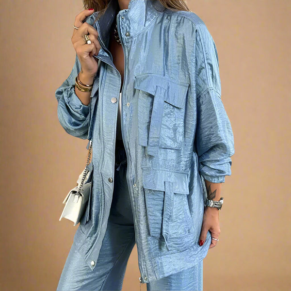 Person wearing a blue denim jacket indoors with a neutral background