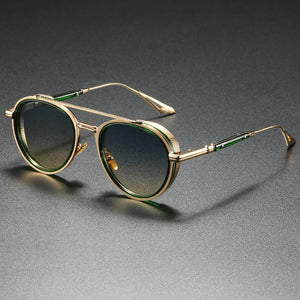 Gold-framed sunglasses with dark lenses on a gray background