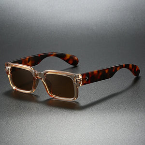 Sunglasses with tortoiseshell frame and brown lenses on a gray background