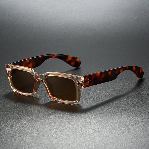 Sunglasses with tortoiseshell frame and brown lenses on a gray background