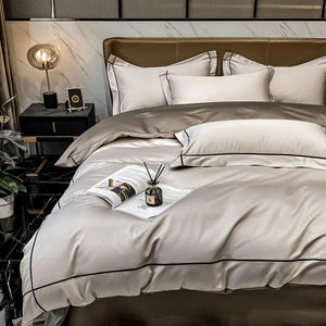 Neatly made bed with beige and white bedding in a modern bedroom setting.