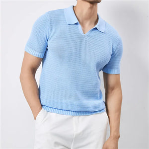 Light blue knitted polo shirt worn by a person on a plain background