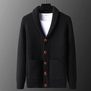 Black cardigan with brown buttons on a gray background