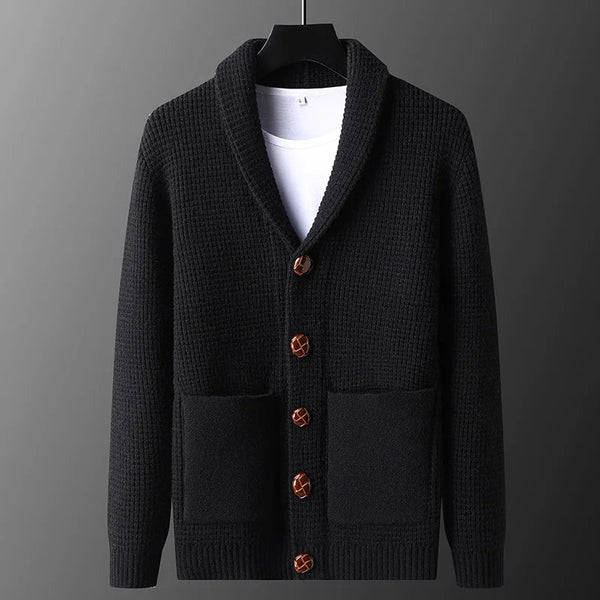Black cardigan with brown buttons on a gray background