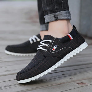 Black checkered shoes with white soles on a wooden floor