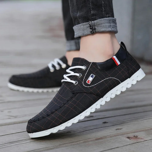 Black checkered shoes with white soles on a wooden floor