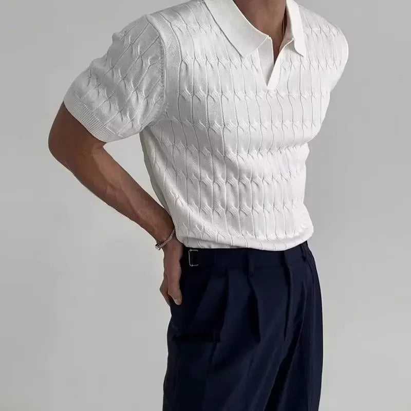 Person wearing a white textured short-sleeve shirt and dark pants on a gray background