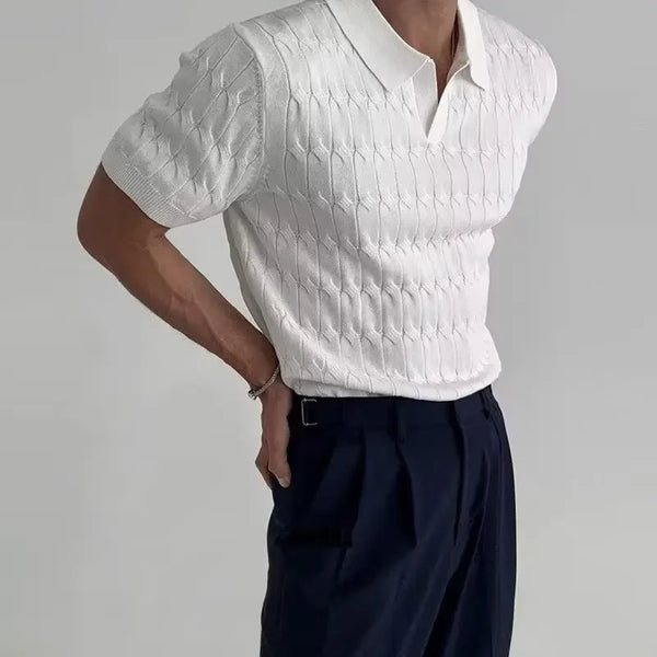 Person wearing a white textured short-sleeve shirt and dark pants on a gray background