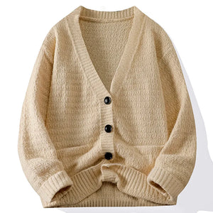 Beige cardigan with black buttons on a white background