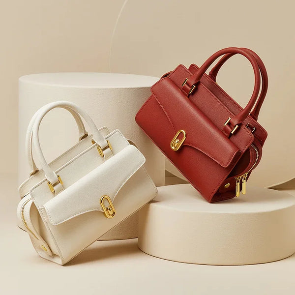 White and red handbags with gold hardware on a beige background