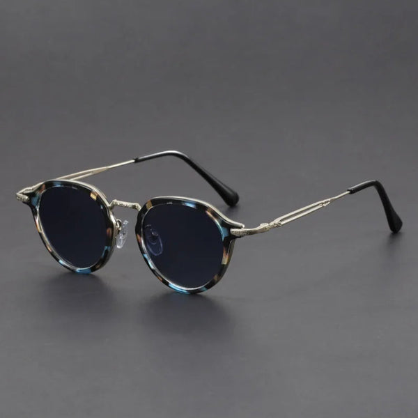 Round sunglasses with metallic frame on a gray background