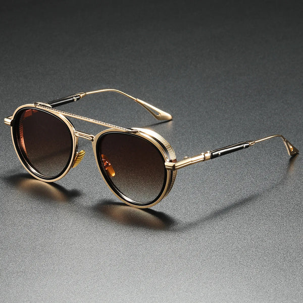 Gold-framed sunglasses with brown lenses on a gray background