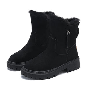 Black suede ankle boots with fur lining on a white background