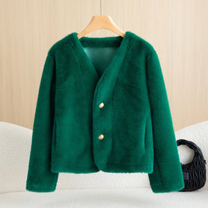 Green jacket on a hanger against a beige wall