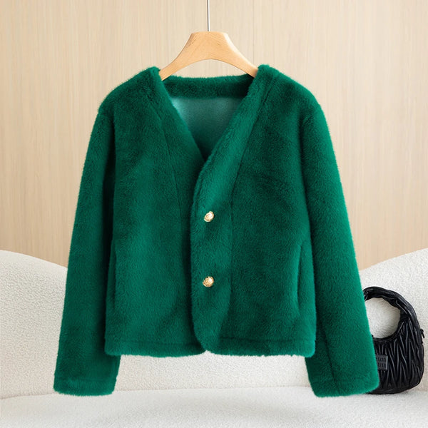 Green jacket on a hanger against a beige wall