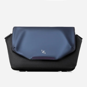 Two-toned blue and black bag with a logo on a white background