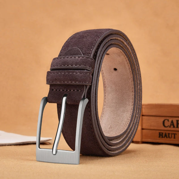 Brown suede belt with silver buckle on a beige background