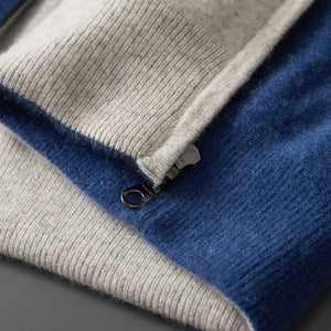 Close-up of a folded blue and gray sweater on a dark surface