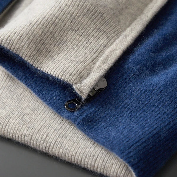 Close-up of a folded blue and gray sweater on a dark surface