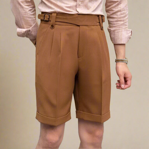 Brown shorts worn by a person on a plain background