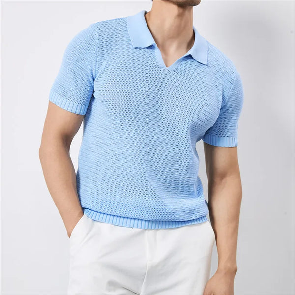 Person wearing a light blue knitted polo shirt against a plain background