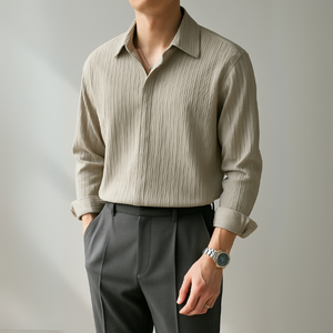Person wearing a beige striped shirt and gray pants against a plain background