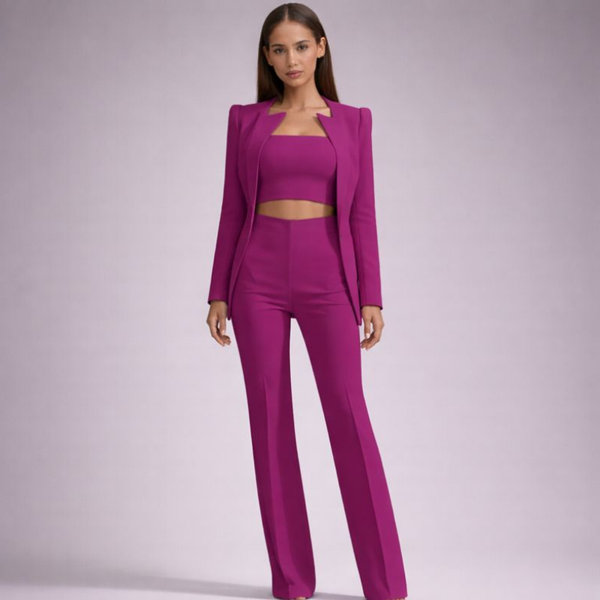 Woman wearing a magenta suit on a plain background