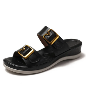 Black sandal with gold buckles on a white background