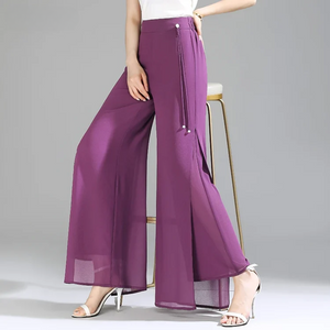 Purple wide-leg pants worn by a person on a gray background