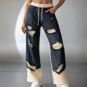 Distressed denim jeans with a neutral background